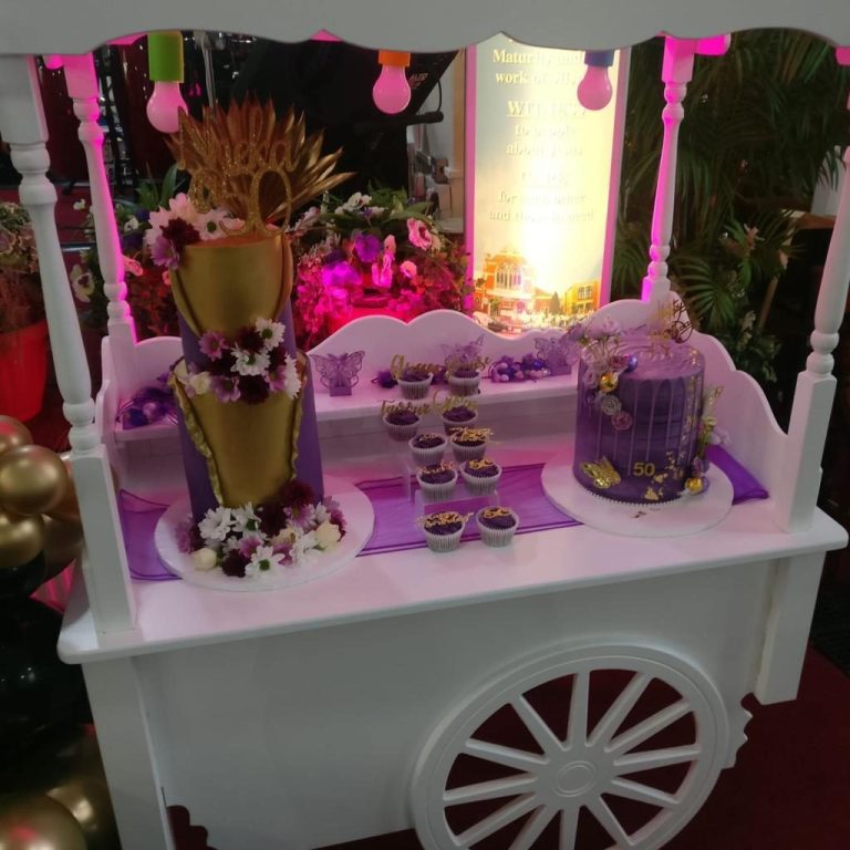 A row of elegant pink gift boxes with ribbons and decorative handles.